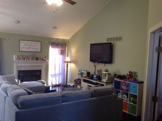 living room with ceiling fan and lofted ceiling