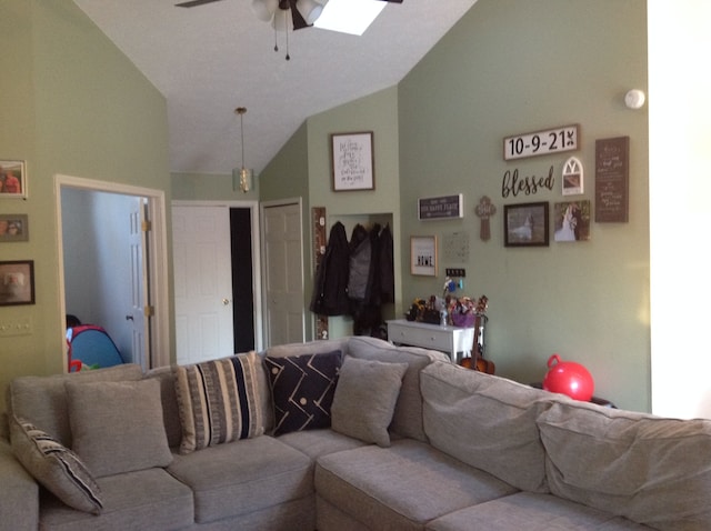 living room featuring ceiling fan and lofted ceiling