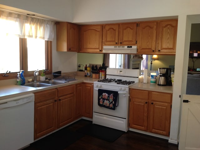 kitchen featuring white appliances and sink