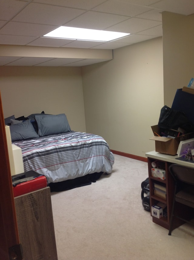 carpeted bedroom with a drop ceiling