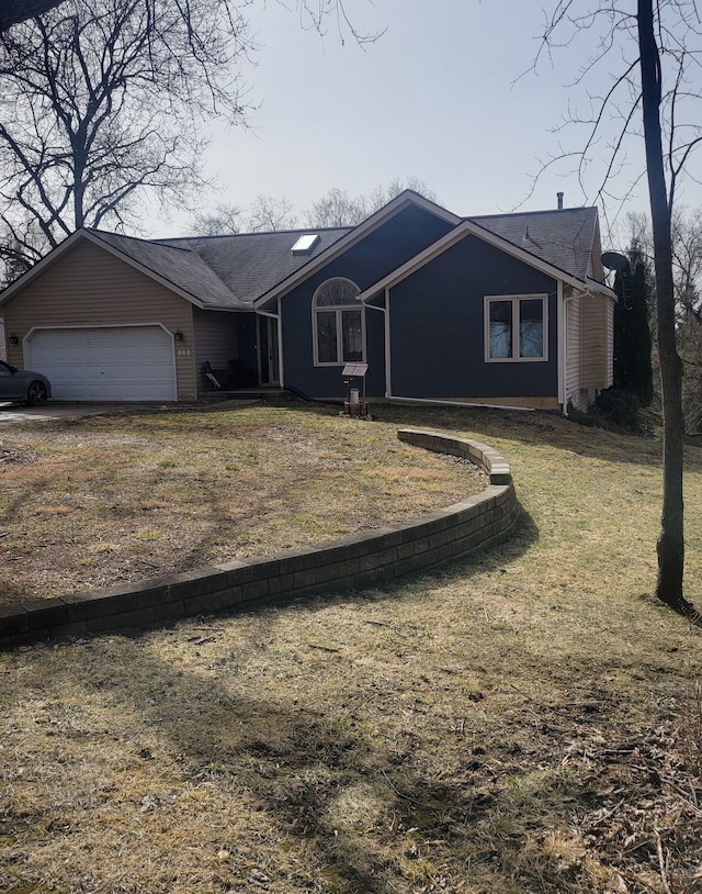 ranch-style home featuring an attached garage and a front yard