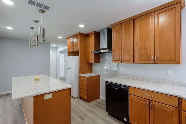 kitchen featuring wall chimney exhaust hood, light wood-type flooring, white refrigerator, black dishwasher, and a kitchen island