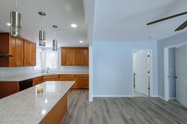 kitchen featuring sink, light hardwood / wood-style flooring, dishwasher, hanging light fixtures, and light stone countertops