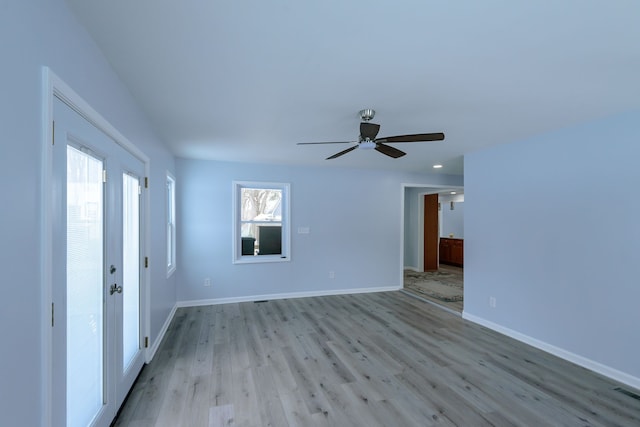 spare room featuring light hardwood / wood-style floors and ceiling fan