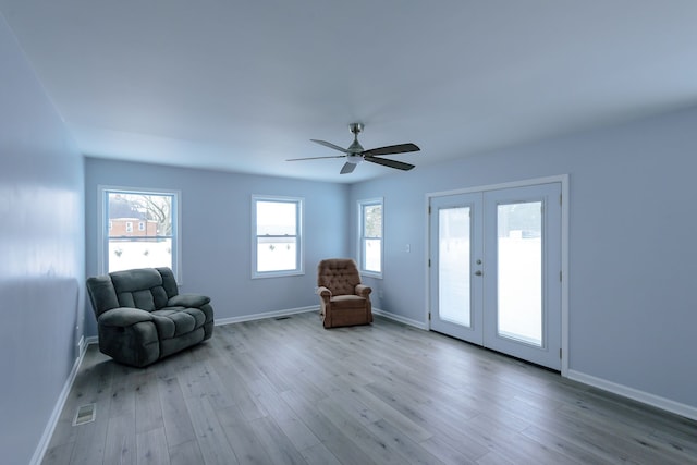 unfurnished room featuring ceiling fan, light wood-type flooring, and french doors