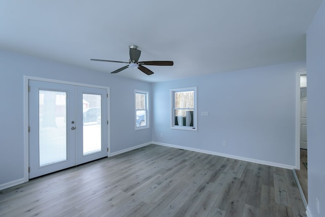 empty room featuring french doors, ceiling fan, and light hardwood / wood-style floors