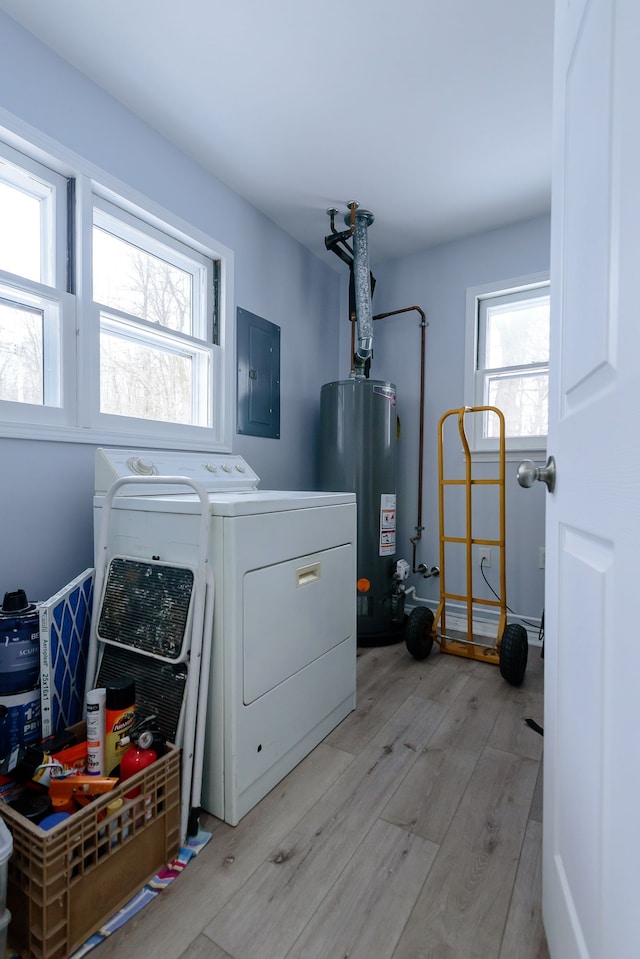 laundry area featuring gas water heater, electric panel, light hardwood / wood-style floors, and washing machine and dryer