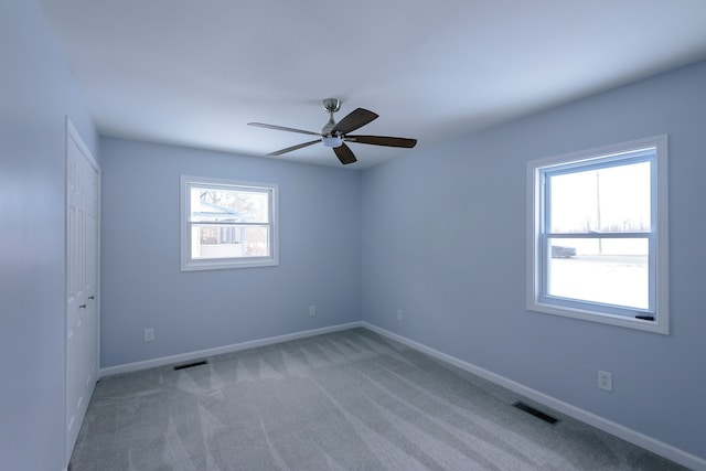 unfurnished room with carpet floors and ceiling fan