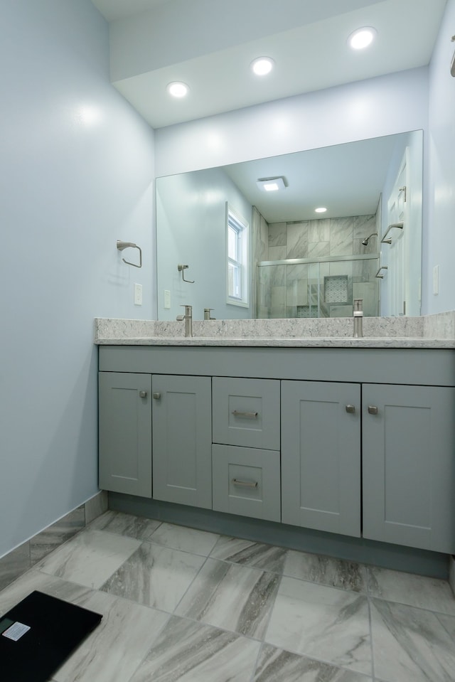 bathroom featuring walk in shower and vanity