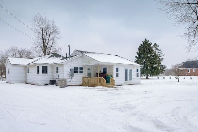 snow covered property with cooling unit