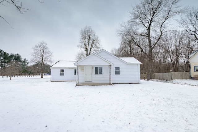 view of snow covered back of property