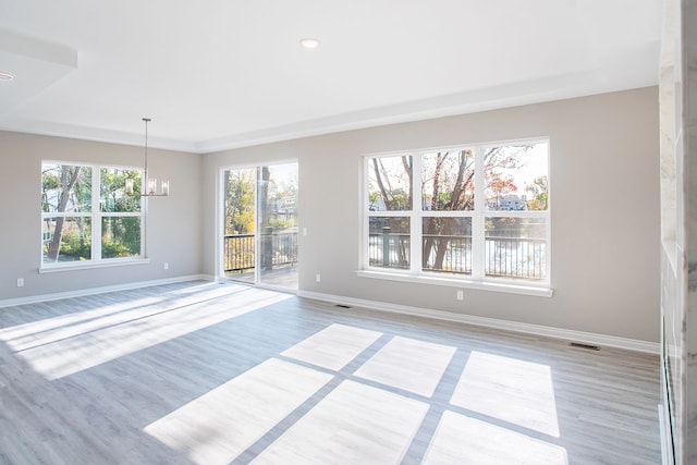 837 Preserve Ln, White Lake, MI 48386 - spare room with a chandelier, light wood finished floors, plenty of natural light, baseboards, and recessed lighting