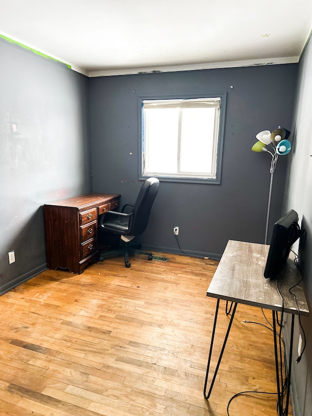 office space with light hardwood / wood-style floors and ornamental molding