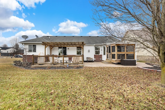 back of property featuring a deck, a patio, a sunroom, a yard, and a pergola