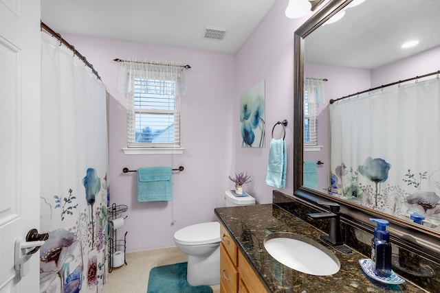 bathroom with toilet and vanity