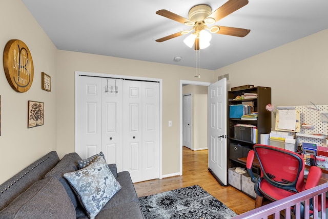 home office featuring ceiling fan and light hardwood / wood-style flooring