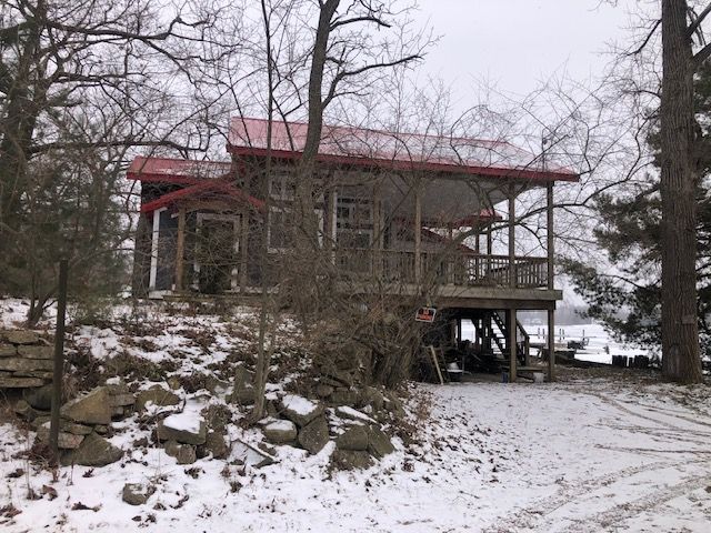 view of snowy exterior featuring a deck