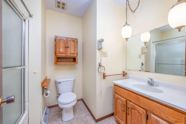 bathroom with tile patterned flooring, vanity, and toilet