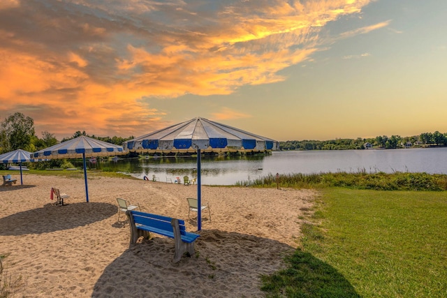 playground at dusk with a water view and a yard