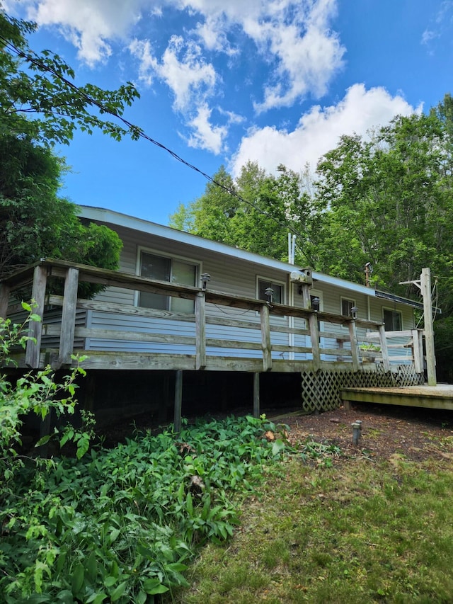 rear view of house featuring a wooden deck