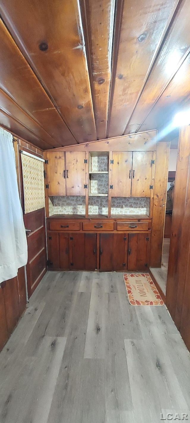 interior space featuring light hardwood / wood-style flooring and wooden ceiling