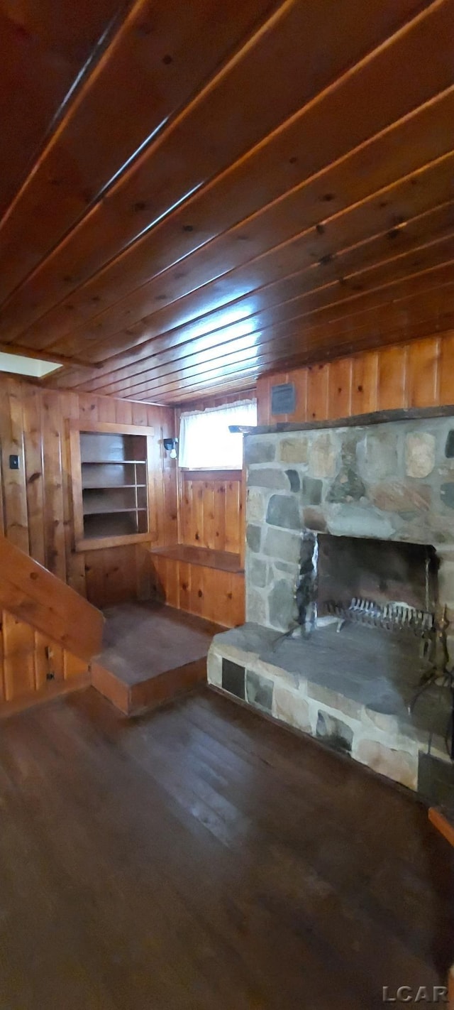 basement featuring wood walls, wood ceiling, and hardwood / wood-style flooring