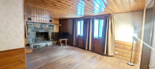 unfurnished living room with hardwood / wood-style floors, a fireplace, and wooden ceiling