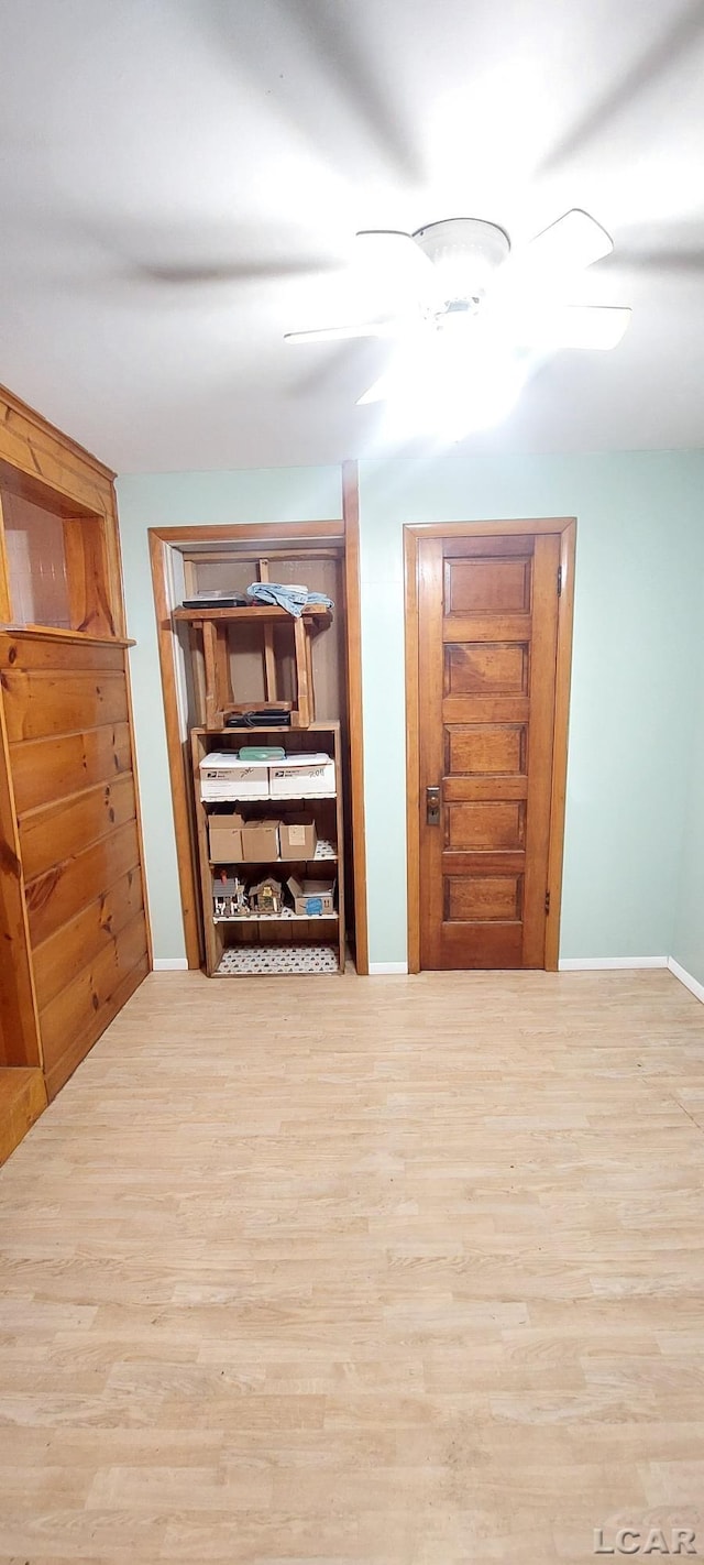 hallway with light hardwood / wood-style flooring