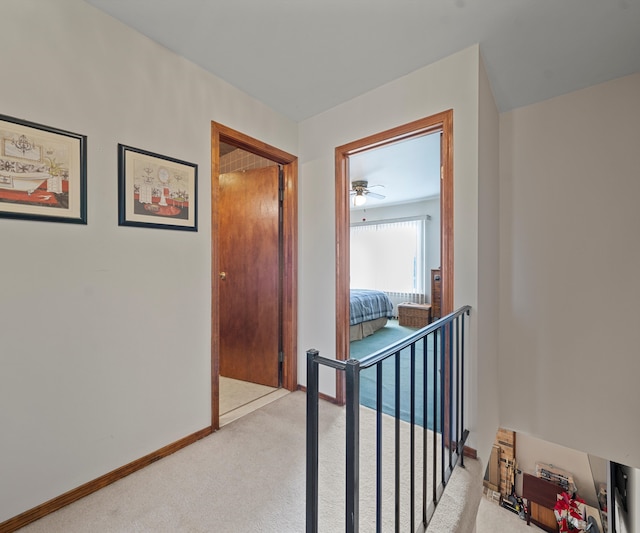 hallway featuring light carpet