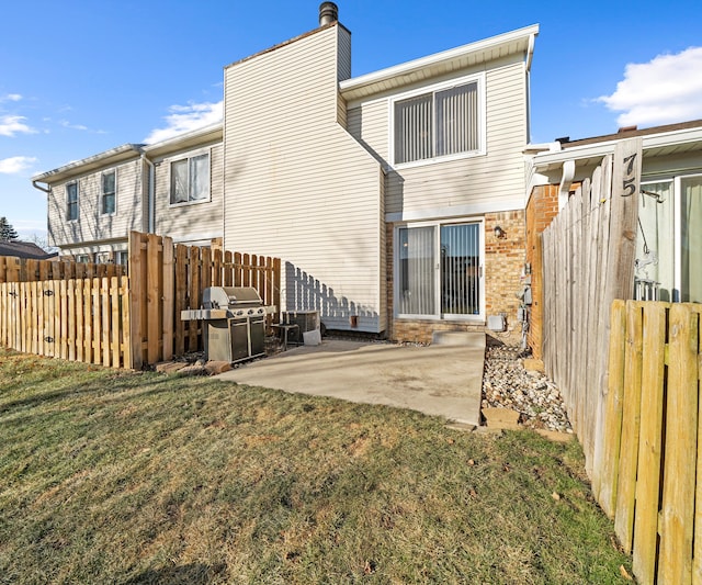 back of property with a patio area and a yard