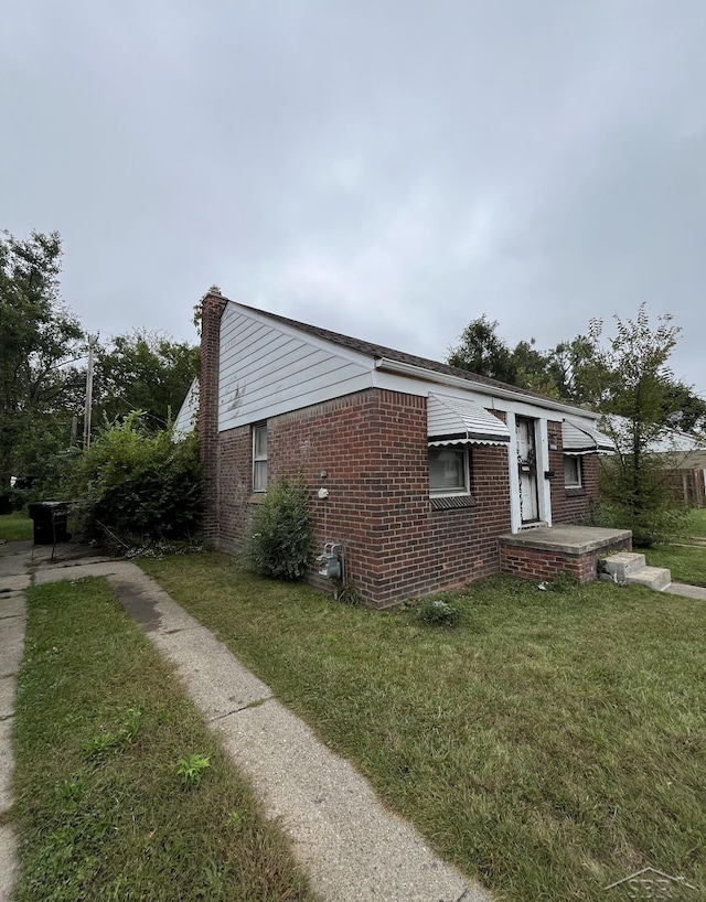 view of side of home featuring a lawn