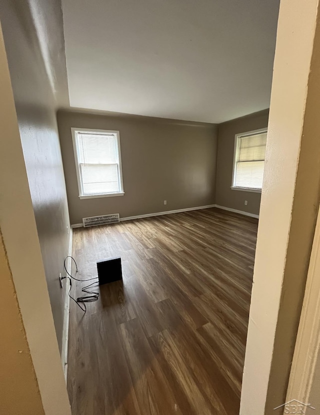 empty room featuring dark wood-type flooring