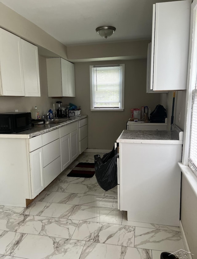 kitchen with white cabinetry and sink