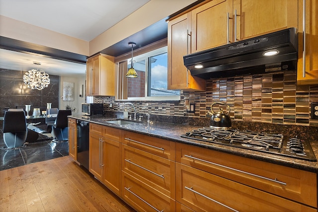 kitchen featuring sink, hanging light fixtures, stainless steel gas cooktop, and tasteful backsplash