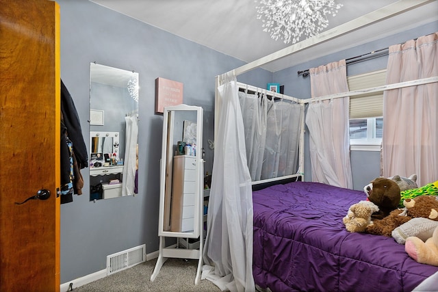 bedroom with a chandelier and carpet