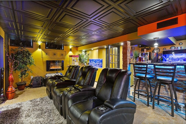 home theater featuring bar area and light carpet