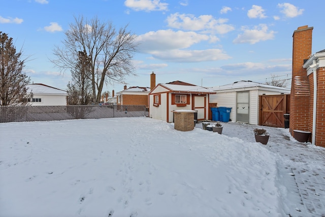 yard layered in snow with a shed