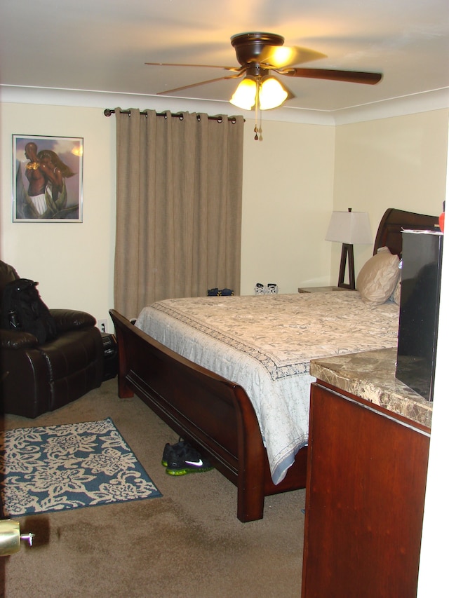 bedroom featuring carpet, ceiling fan, and crown molding