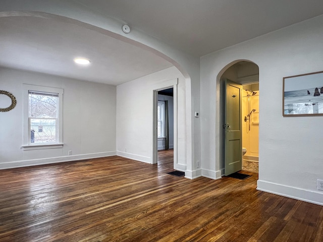 spare room featuring dark hardwood / wood-style flooring