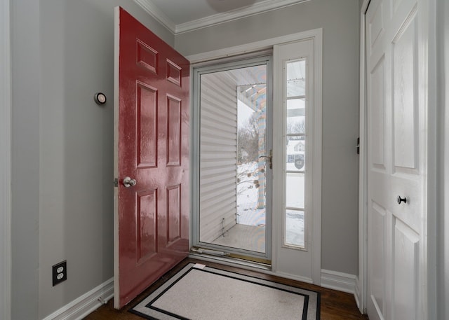 foyer entrance featuring dark hardwood / wood-style flooring, crown molding, and plenty of natural light