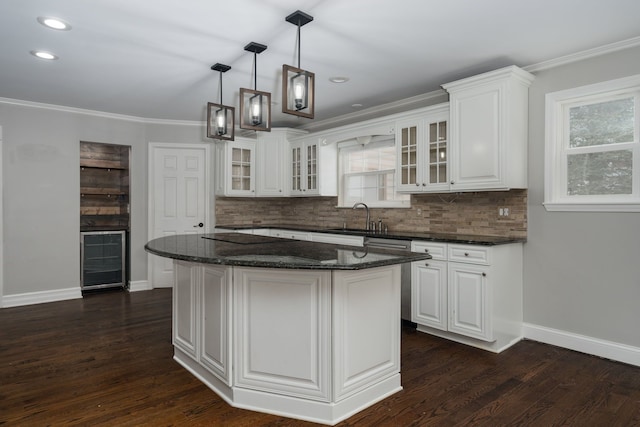 kitchen with a center island, white cabinets, and sink