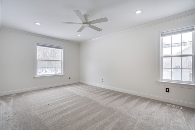 empty room with light carpet, ceiling fan, and ornamental molding