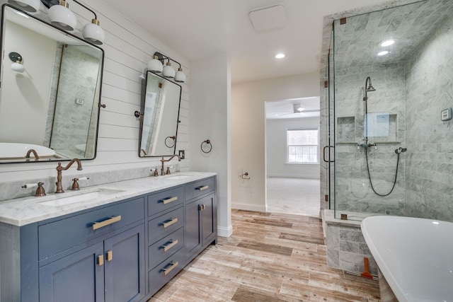 bathroom featuring hardwood / wood-style flooring, ceiling fan, independent shower and bath, and vanity