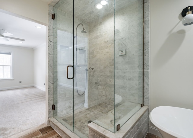 bathroom featuring crown molding, plus walk in shower, and ceiling fan