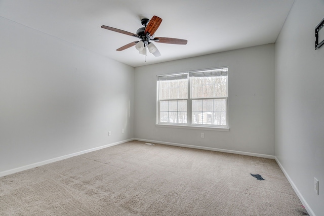 spare room with carpet flooring and ceiling fan