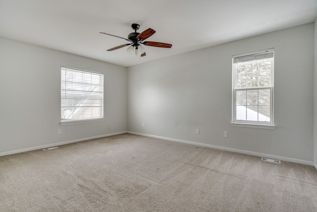 unfurnished room with ceiling fan and light colored carpet