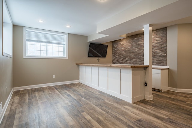 bar with white cabinetry and dark wood-type flooring