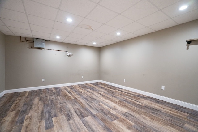 basement featuring hardwood / wood-style flooring and a drop ceiling