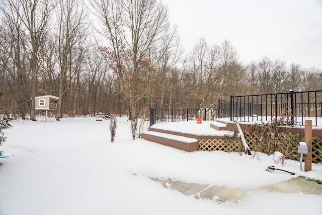 yard covered in snow featuring a wooden deck