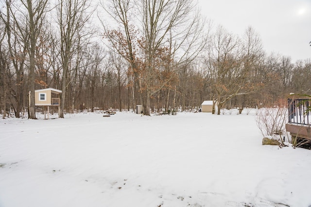 yard covered in snow featuring an outdoor structure